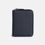 Atlas passport wallet in navy full-grain leather, closed, zip running around three sides